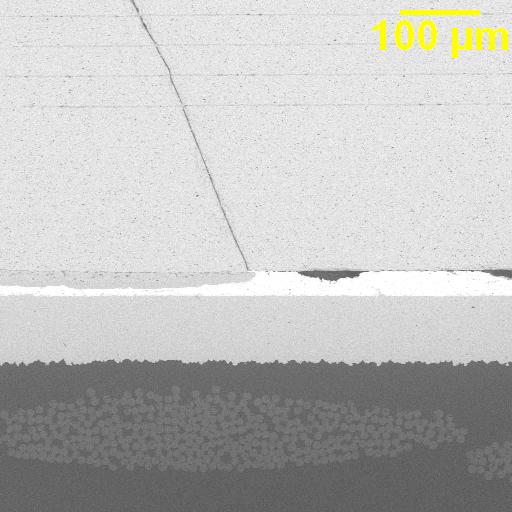 MLCC microsection showing a fracture path bridging opposite-polarity electrodes