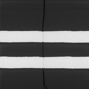 Failure analysis of a PCB showing a parallel section of an inner layer. A crack propagated through these copper traces.