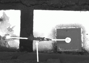 This is a chemically decapsulated SMD diode that failed due to excessive current electrical overstress (EOS). The bond wire fuses open near the center of the span because it is heat-sunk at both ends.