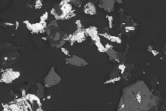 SEM image [100X base magnification] at 15 KeV of copper particles (bright contrast) and aluminum oxide particles (intermediate contrast) on clean carbon tape (dark background).