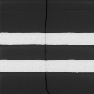 Failure analysis of a PCB showing a parallel section of an inner layer. A crack propagated through these copper traces.