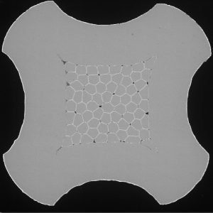 Metallographic section of crimped connector pin.