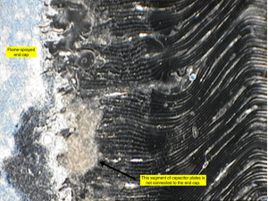 This is a microsection at the end cap showing a region where the endcap is not connected to the capacitor plates, which would likely result in lower than expected capacitance.