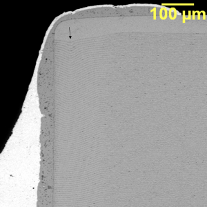 The distortion in the plate structure suggests there was a fabrication anomaly associated with this MLCC capacitor.